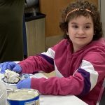 a 4th grade girl making a bird feeder